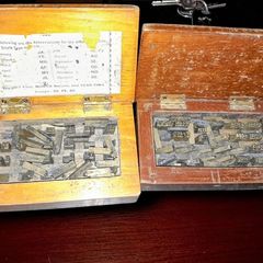 Antique printing equipment in wooden boxes