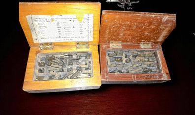 Antique printing equipment in wooden boxes