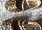 . Brand new in box , pair of girls gold shoes
