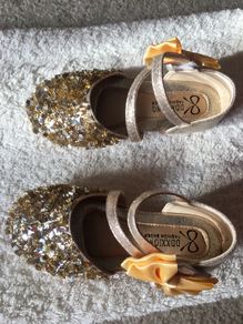. Brand new in box , pair of girls gold shoes