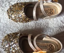 . Brand new in box , pair of girls gold shoes