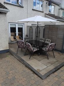 garden table with six chairs and parasol