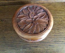 Wooden circular box with carved leaf pattern