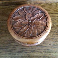 Wooden circular box with carved leaf pattern