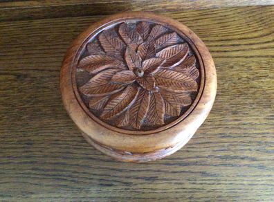 Wooden circular box with carved leaf pattern