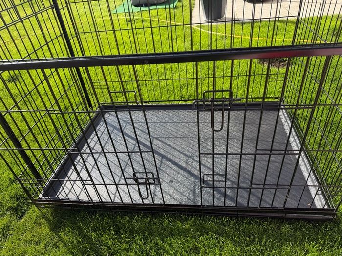XL dog crate opens up by sliding doors at front and side. Read caption