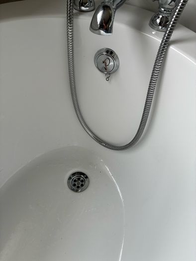 free standing bath with taps and and hose