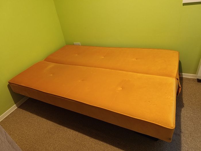 Yellow velvet sofa bed with storage