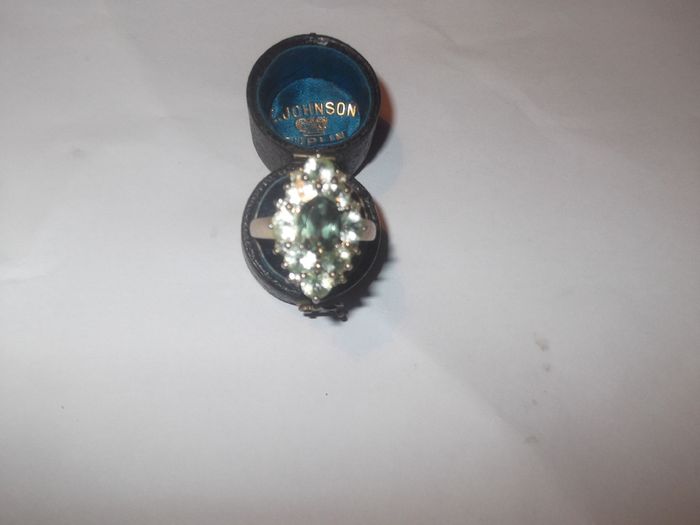 a silver dress ring with white stones  and a green stone stamped 925 china