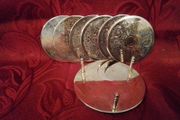 Set of Six Silvered Coasters in a Stand