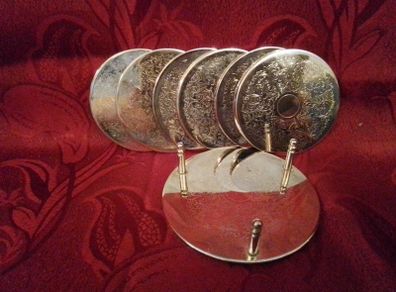 Set of Six Silvered Coasters in a Stand