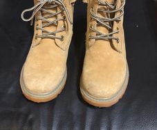 pair of tan/wheat leather boots with a padded dark brown collar.