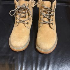 pair of tan/wheat leather boots with a padded dark brown collar.