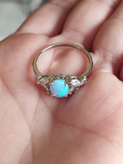 Ring made of 925 silver with oval opal of blue shade and cubic zirconia.