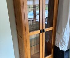 Solid oak display cabinet with glass shelves