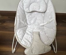 This is a Red Kite Bambino baby bouncer in a grey elephant design