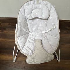 This is a Red Kite Bambino baby bouncer in a grey elephant design