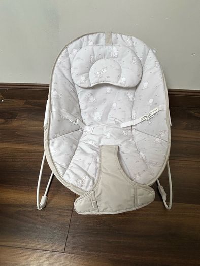 This is a Red Kite Bambino baby bouncer in a grey elephant design