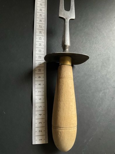 vintage meat carving fork is made of solid steel with a wooden handle and guard possible 1966 British army