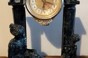 Black clock with family figurines
