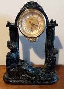 Black clock with family figurines