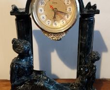 Black clock with family figurines