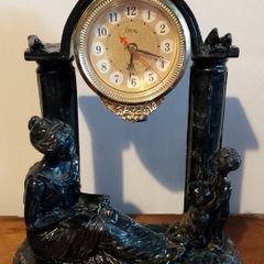 Black clock with family figurines