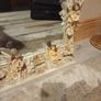 Rococo style wall mirror features a heavy, ornate resin frame decorated with carved cherubs and floral motifs Image 3