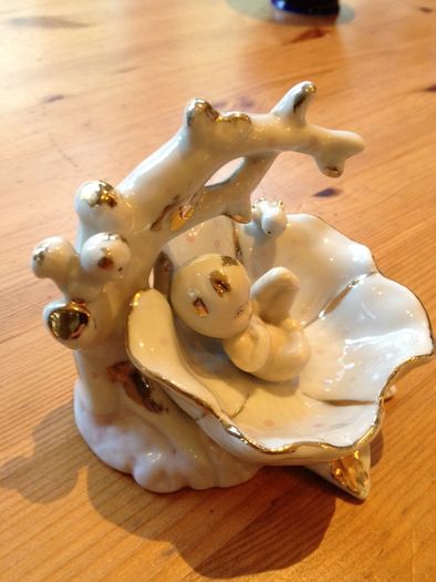 Beautiful porcelain baby in a flower
