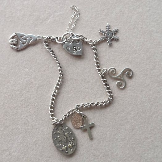 Vintage sterling silver bracelet with charms. Please note that only one charm is not sterling silver. It is a small size, approximately 16/17 cm.