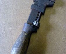 Very small wooden handled adjustable wrench