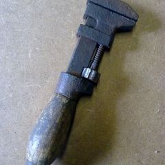 Very small wooden handled adjustable wrench