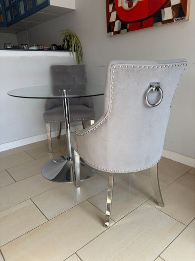Glass table with velvet studded chairs