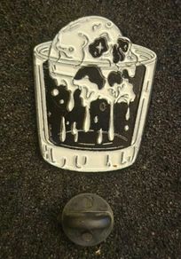 Skull, pin back badge.