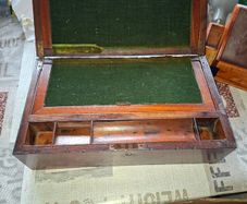 19th Century Victorian writing slope. It features a hinged lid that opens to create a sloped writing surface, traditionally lined with velvet. The box includes built-in compartments for storing pens, inkwells, and documents., postage available