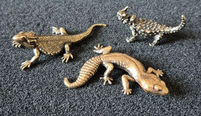 3 brass lizards.