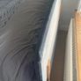 Upholstered grey double bed base with storage and headboard Image 2