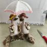 Decorative figurine featuring a duck couple setting on tree brunch. Image 2
