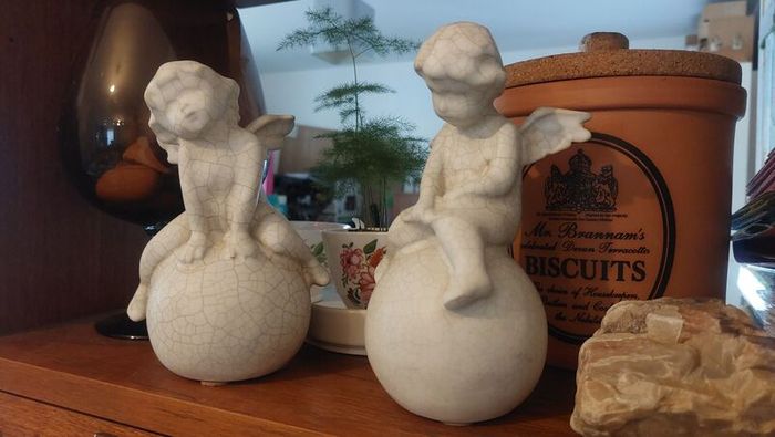 Lovely Vintage Pair of Ceramic Baby Winged Angels Sitting on Globes with a Very Tactile Cream Coloured Crackle Glaze