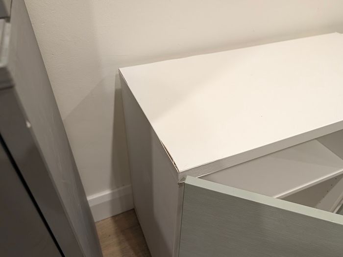 White TV unit with grey-green doors