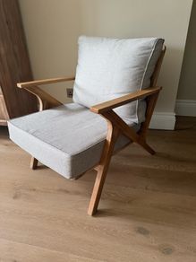 Acacia wood lounge armchair with grey cushions
