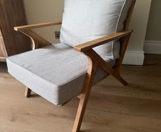 Acacia wood lounge armchair with grey cushions