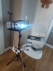 philips neopix ultra 2tv+ home projector and height adjustable stand, built in speakers and android TV with play store stand comes with power point bracket on it as seen in pictures also remote and phone holder