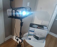 philips neopix ultra 2tv+ home projector and height adjustable stand, built in speakers and android TV with play store stand comes with power point bracket on it as seen in pictures also remote and phone holder