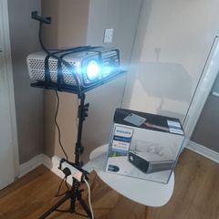 philips neopix ultra 2tv+ home projector and height adjustable stand, built in speakers and android TV with play store stand comes with power point bracket on it as seen in pictures also remote and phone holder