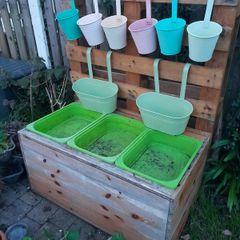 Wooden Ikea trofast storage unit with 3 green boxes and 8 metal planters pots