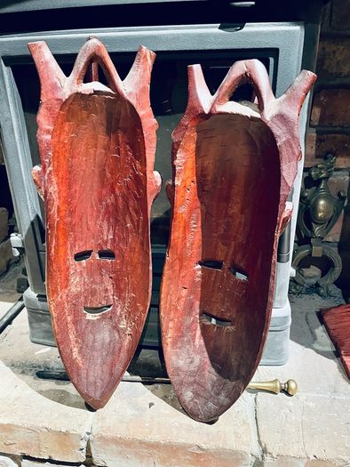 Two carved tribal masks