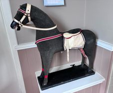 Vintage stuffed horse on plinth