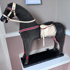 Vintage stuffed horse on plinth