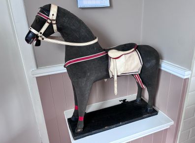 Vintage stuffed horse on plinth